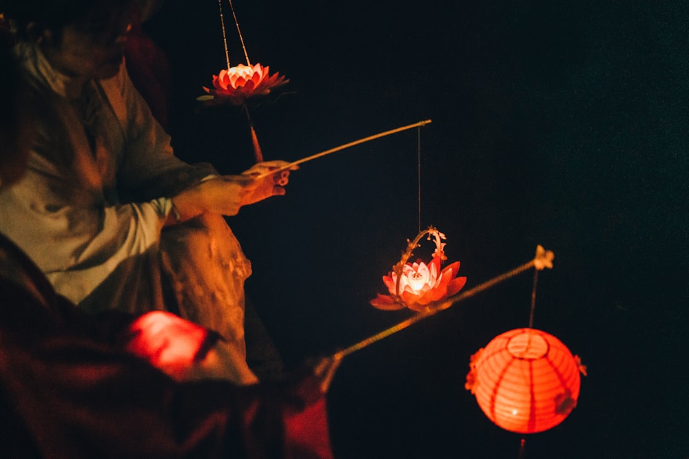 man holding lighted lantern