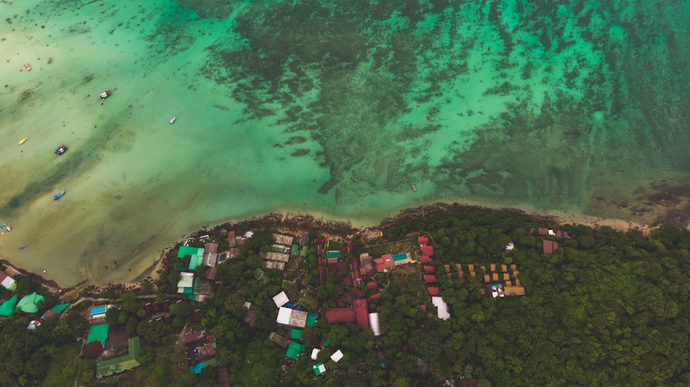 an aerial view of a beach with boats in the water