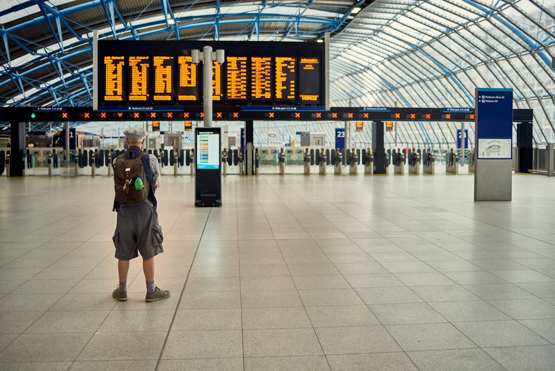 man standing in front of airport station, 