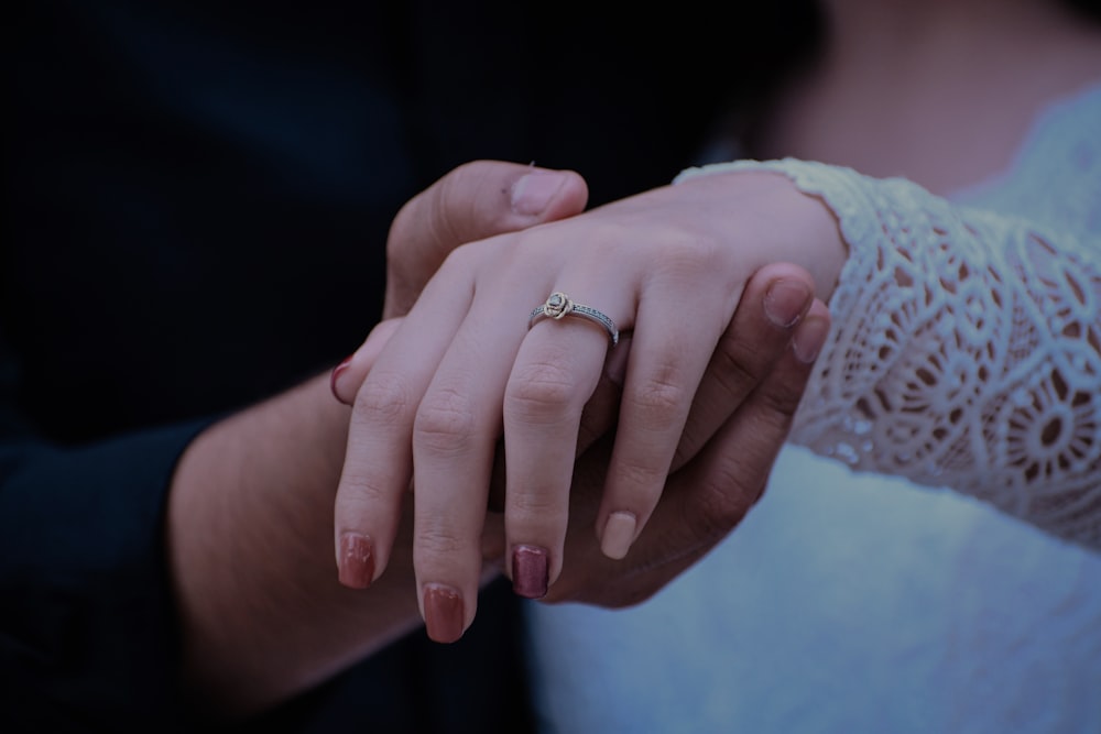 woman wearing gold-colored ring