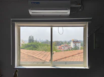 Close-up of soundproof PVC window installed in a cozy apartment setting.