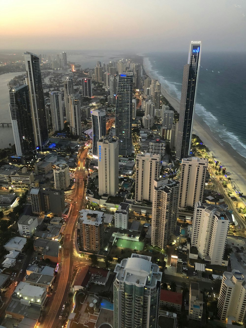 aerial photography of concrete buildings beside sea