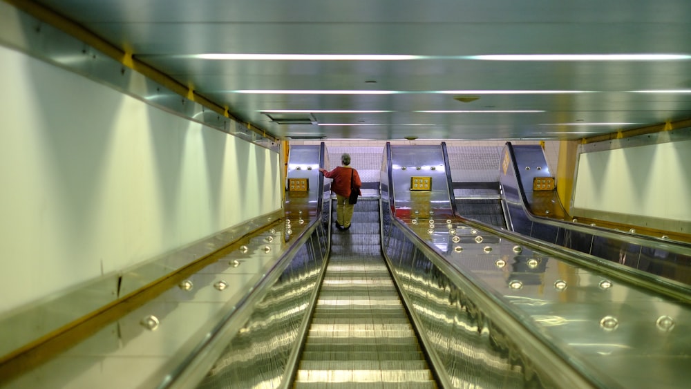 a man riding an escalator down an escalator