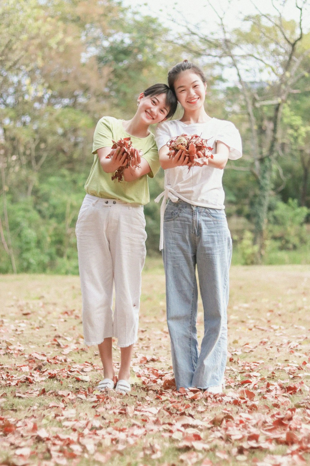 2 girls holding dried leaves