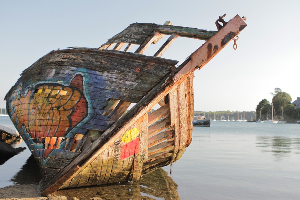brown boat with graffiti