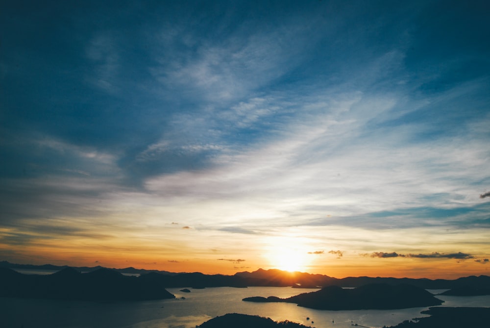 rocks and body of water during sunset photo