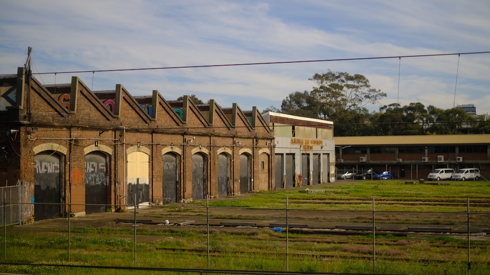 cars parked on beside brown building