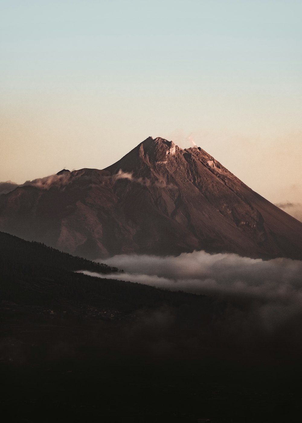 photo of brown mountain and white clouds