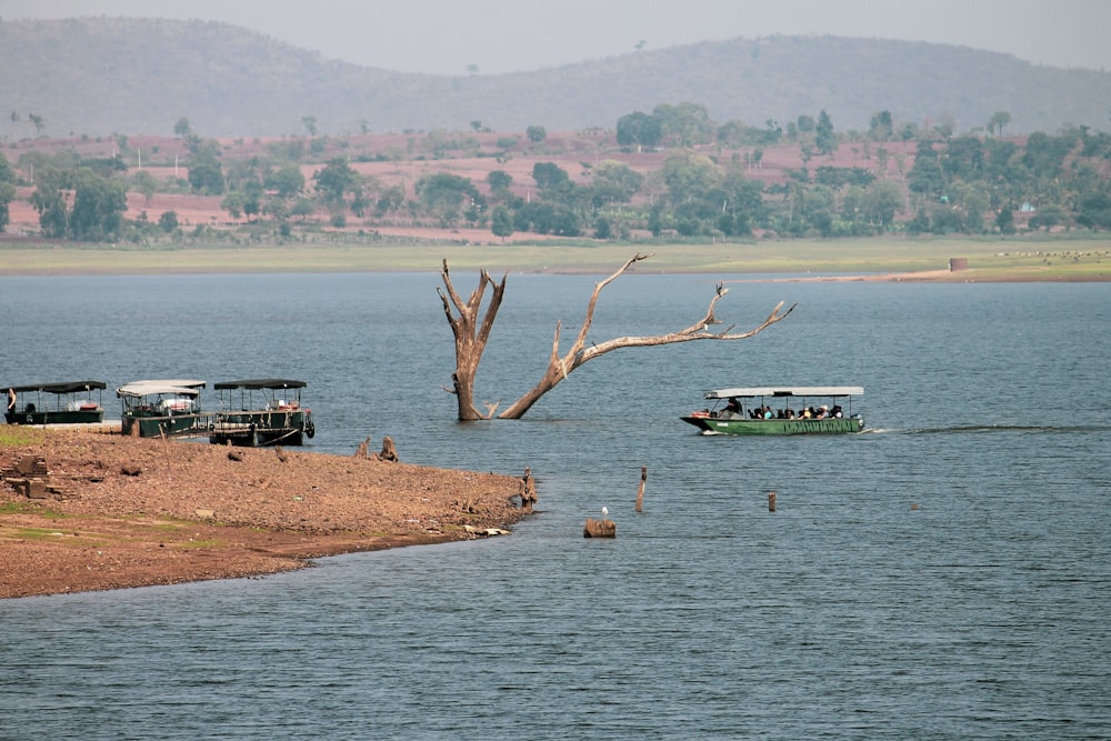 several water buses on body of water near island