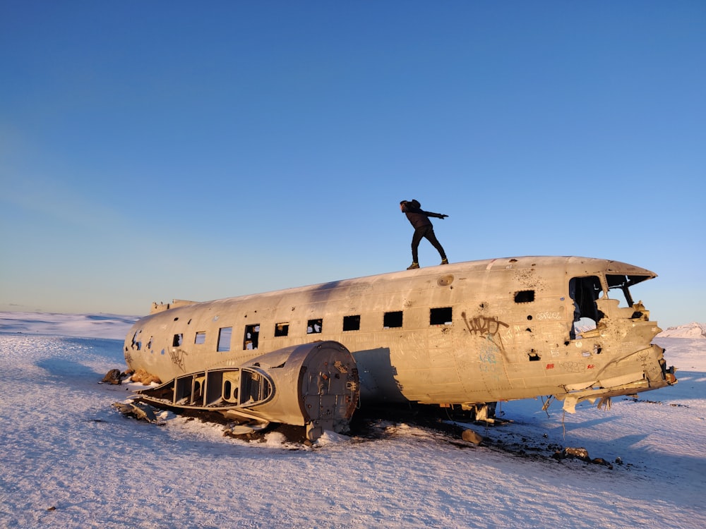person standing on wrecked airplane