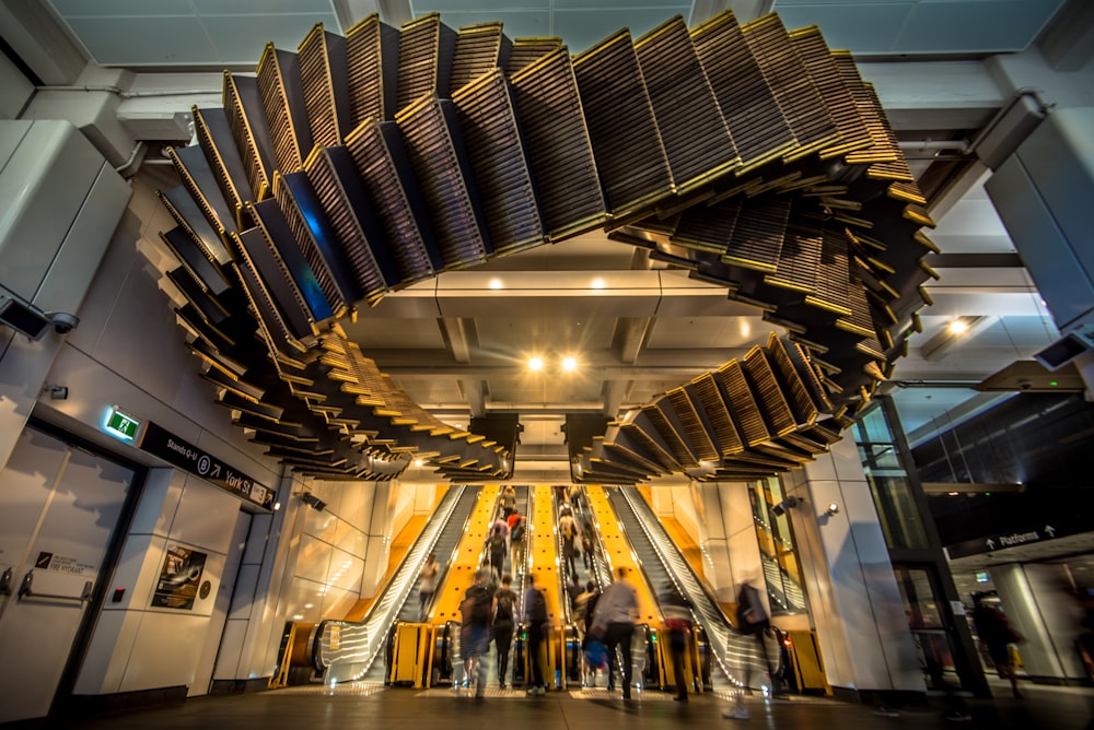 people inside building with escalators