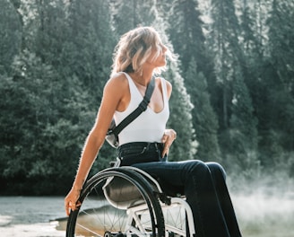 woman riding wheelchair along a trail