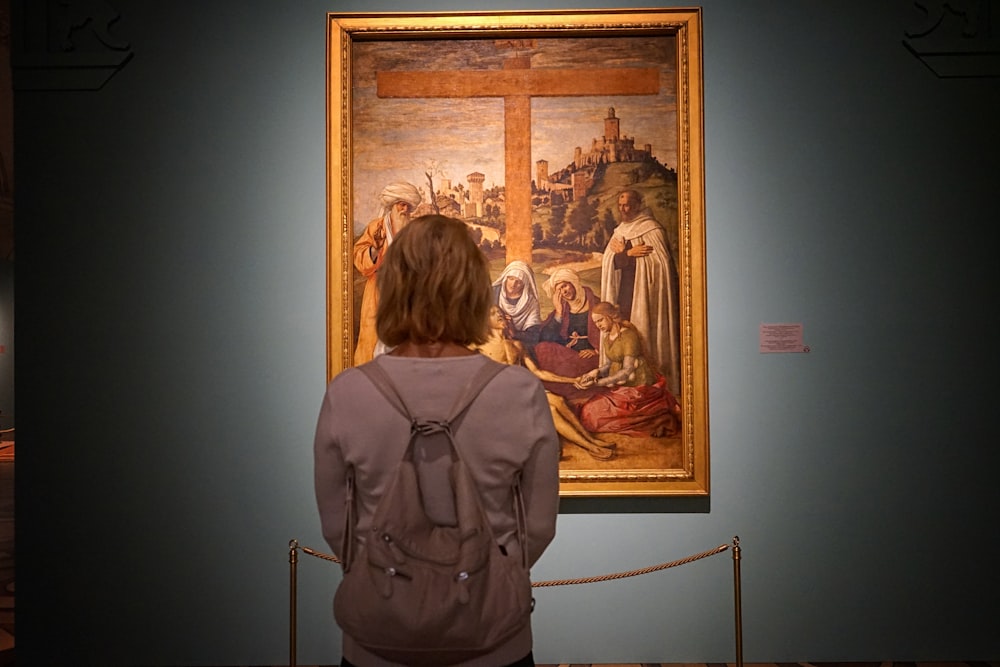 woman standing in front of painting