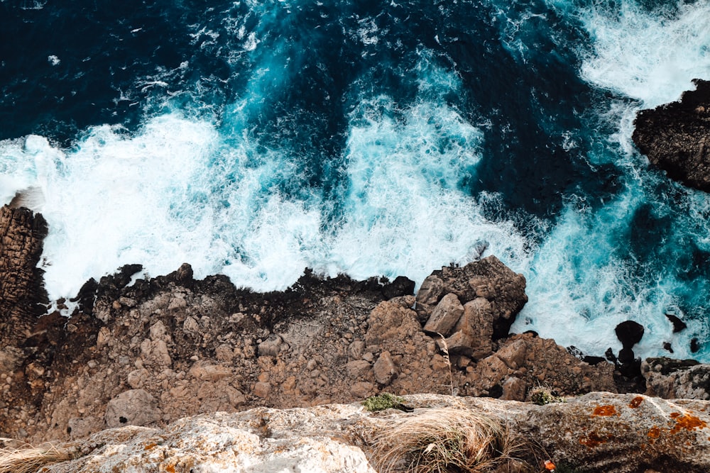 brown cliff by the body of water