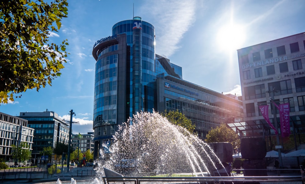 a water fountain in front of a large building