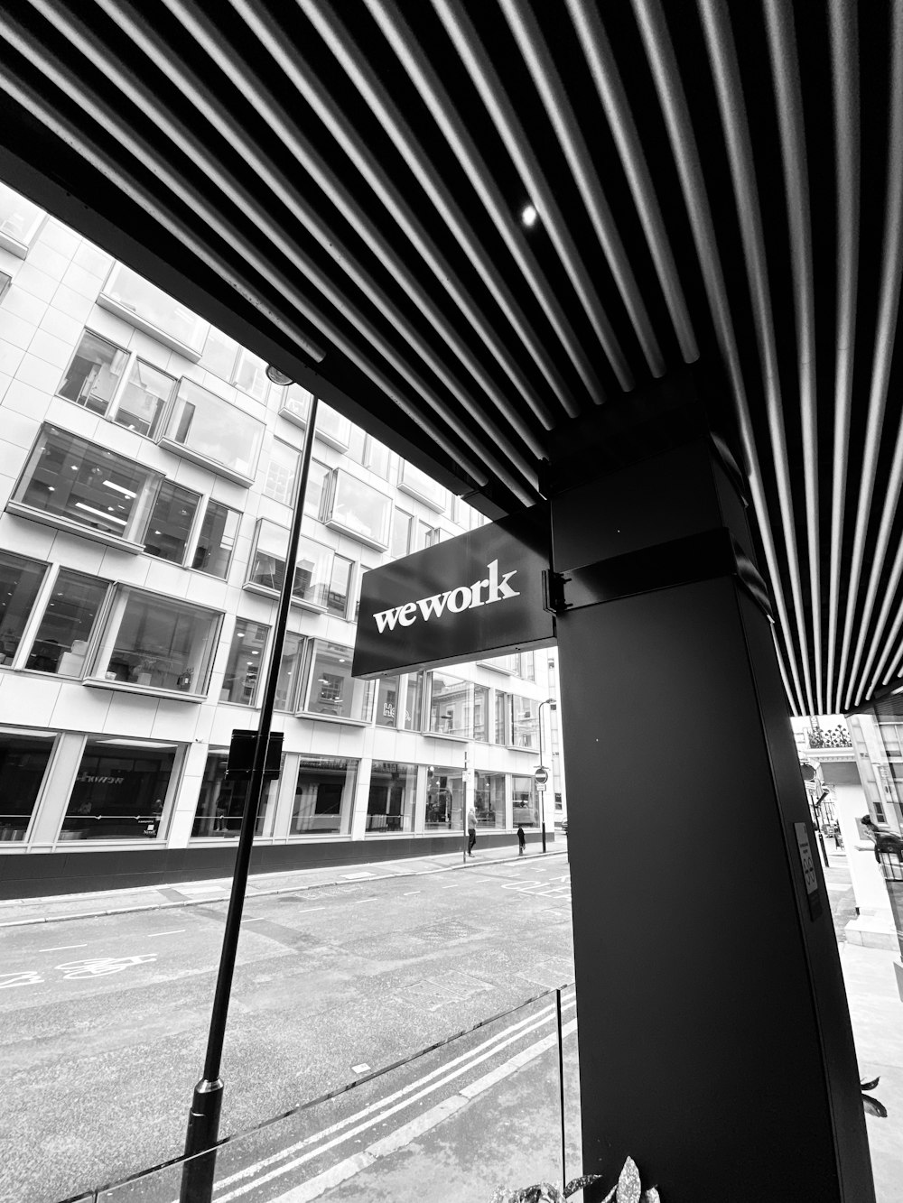 grayscale photography of wework signage
