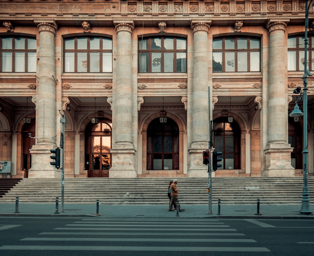 person walking pass building