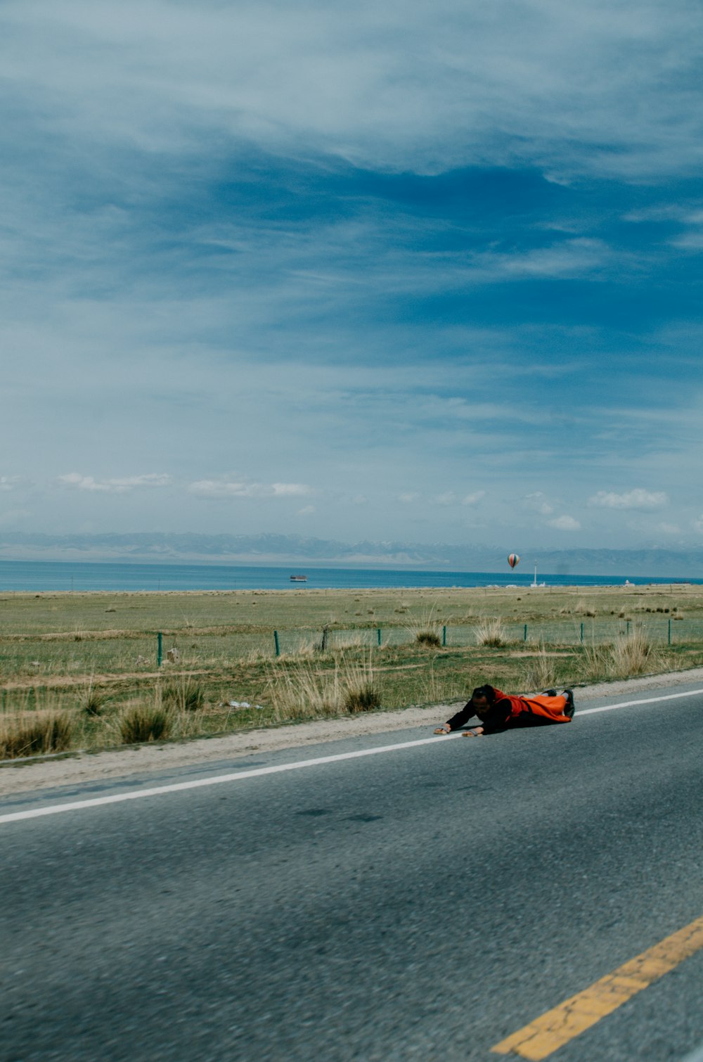 person lying on road