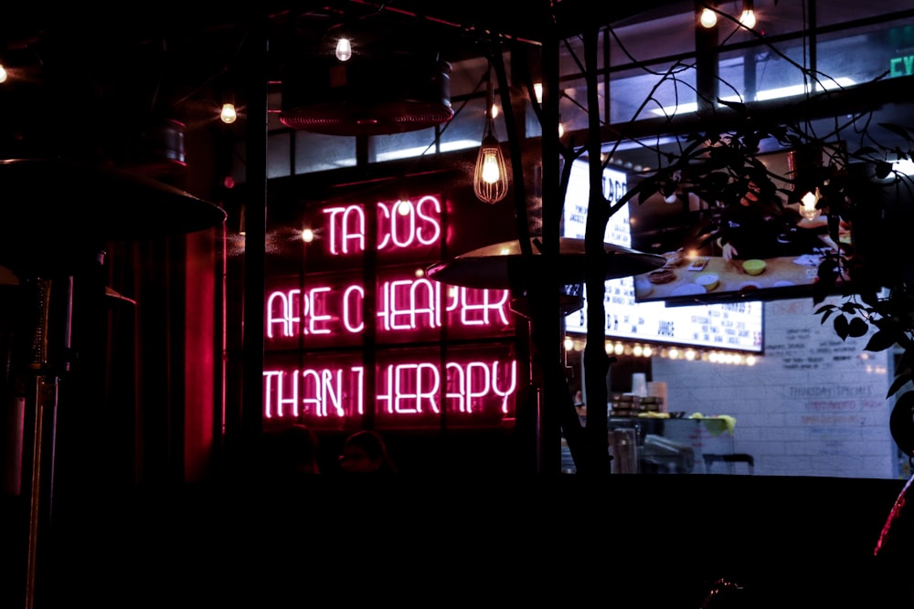 a neon sign in a dark room with lights