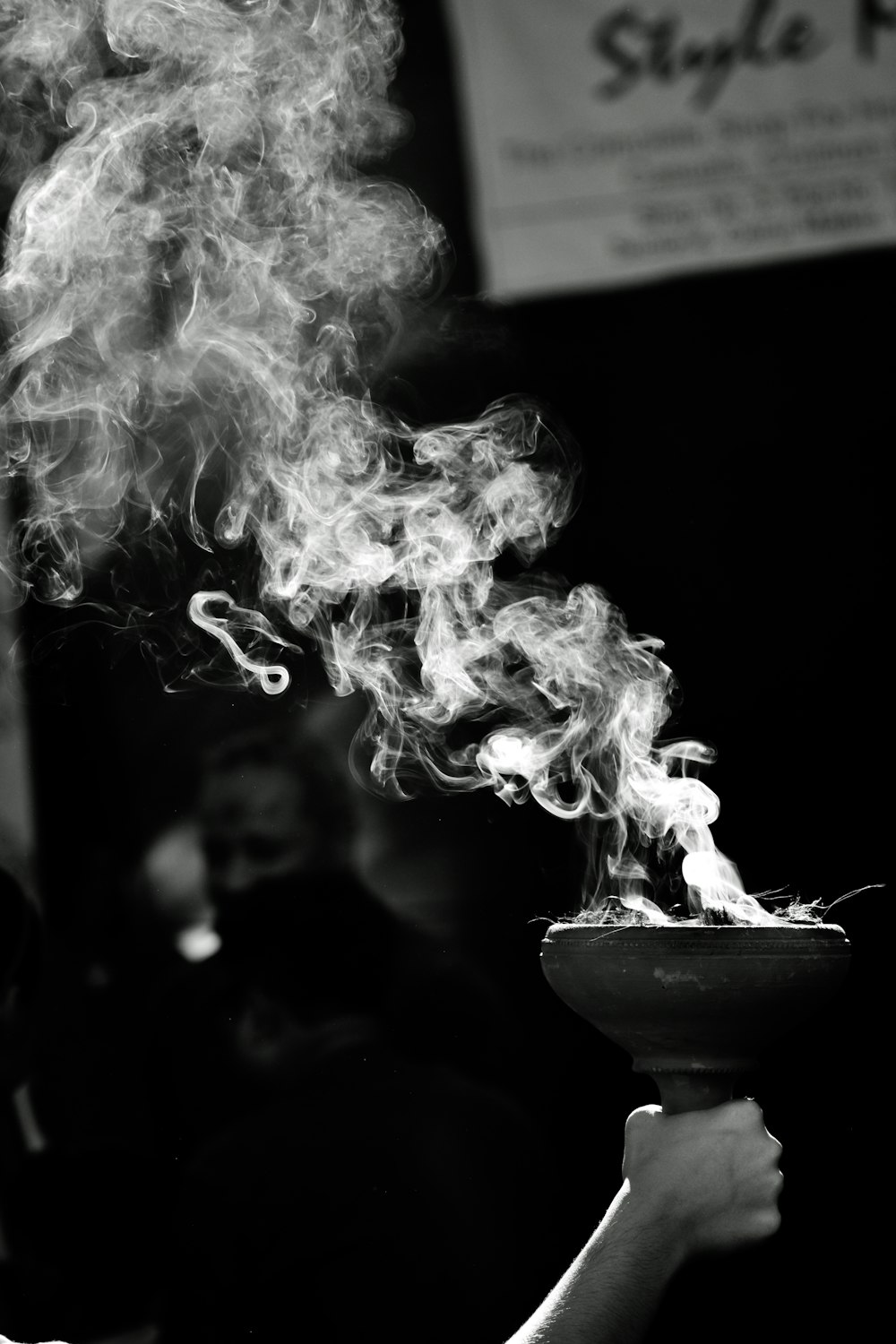 person holding torch grayscale photo