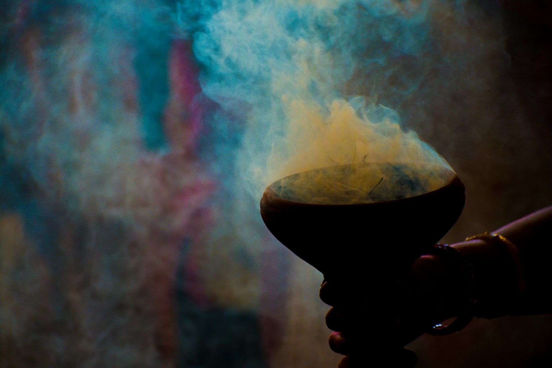 person holding bowl with smoke coming out