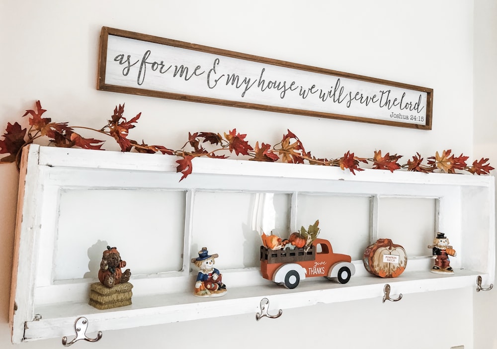 a shelf with a bunch of figurines on top of it