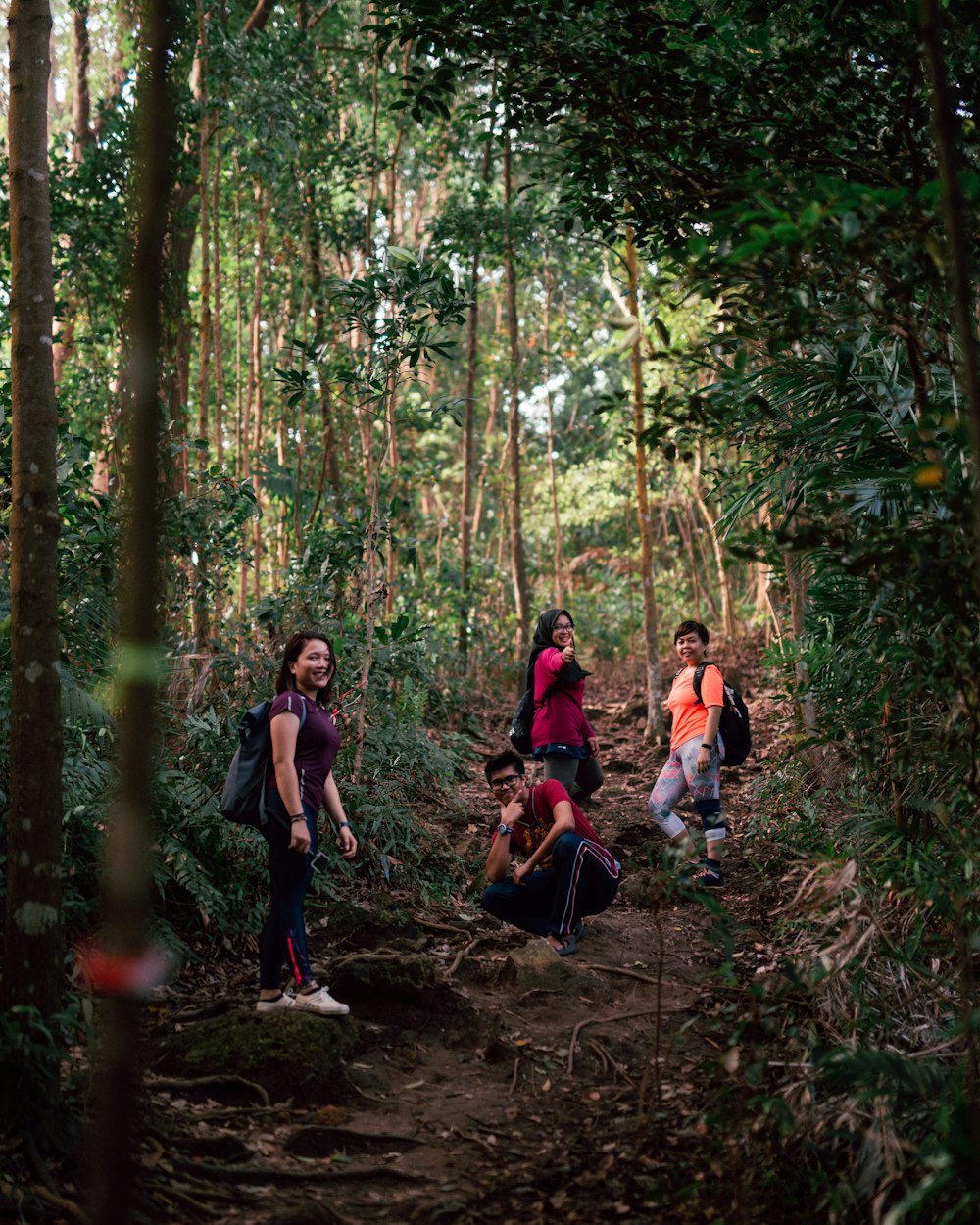 man and women trekking in forest