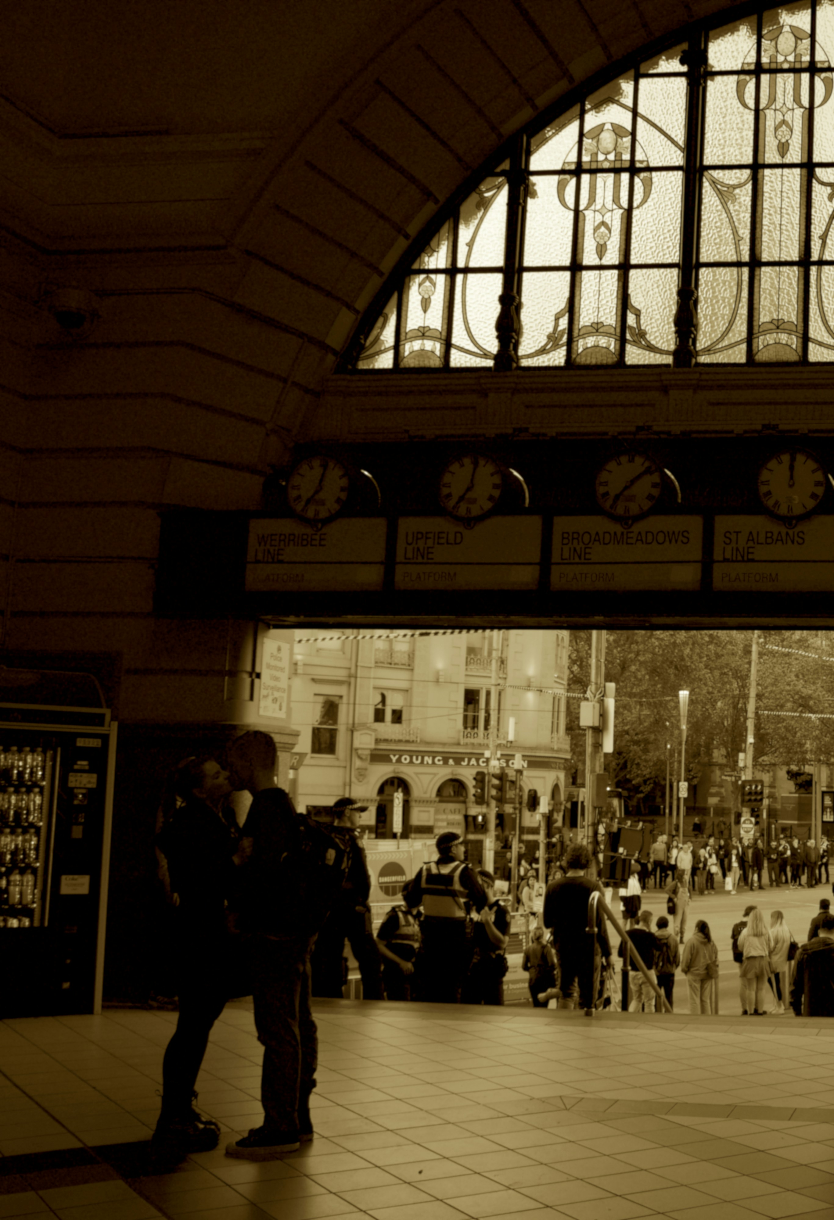 Two silhouettes meeting at train station in gentle snowfall, warm cinematic lighting, romantic reunion