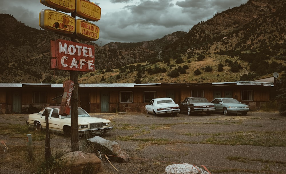 vehicles parking beside wooden Motel cafe at daytime