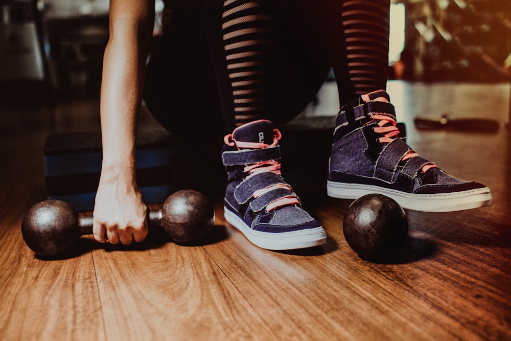 a person with their feet on a pair of exercise balls