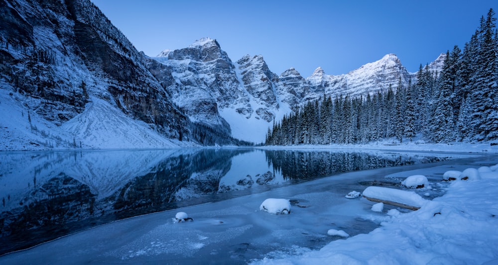 lake viewing mountain covered with snow during daytime