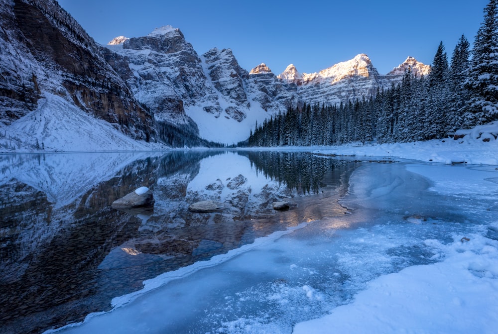 snow covered lake under blue sky