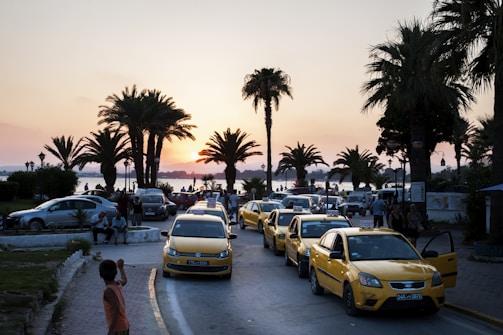 A sleek taxi cruising along a scenic Cork coastal road at sunset