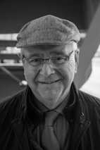 A smiling retired government worker receiving advice on pension credits from a consultant.