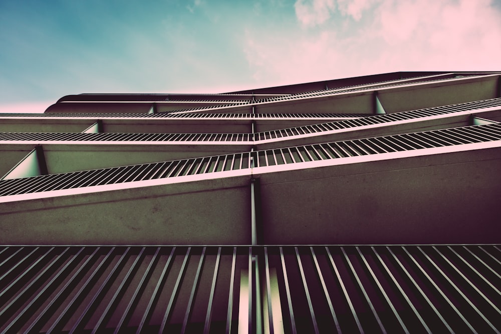 low-angle photography of gray and white concrete building under white sky