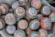 A selection of colorful cricket balls arranged neatly on a wooden surface