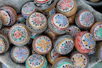 A selection of colorful cricket balls arranged neatly on a wooden surface