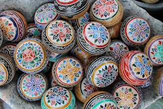 A close-up of a colorful assortment of balls arranged on a wooden table, highlighting textures and patterns.
