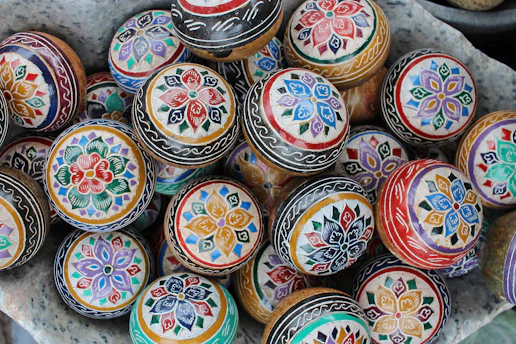 A close-up of a colorful assortment of balls arranged on a wooden table, highlighting textures and patterns.