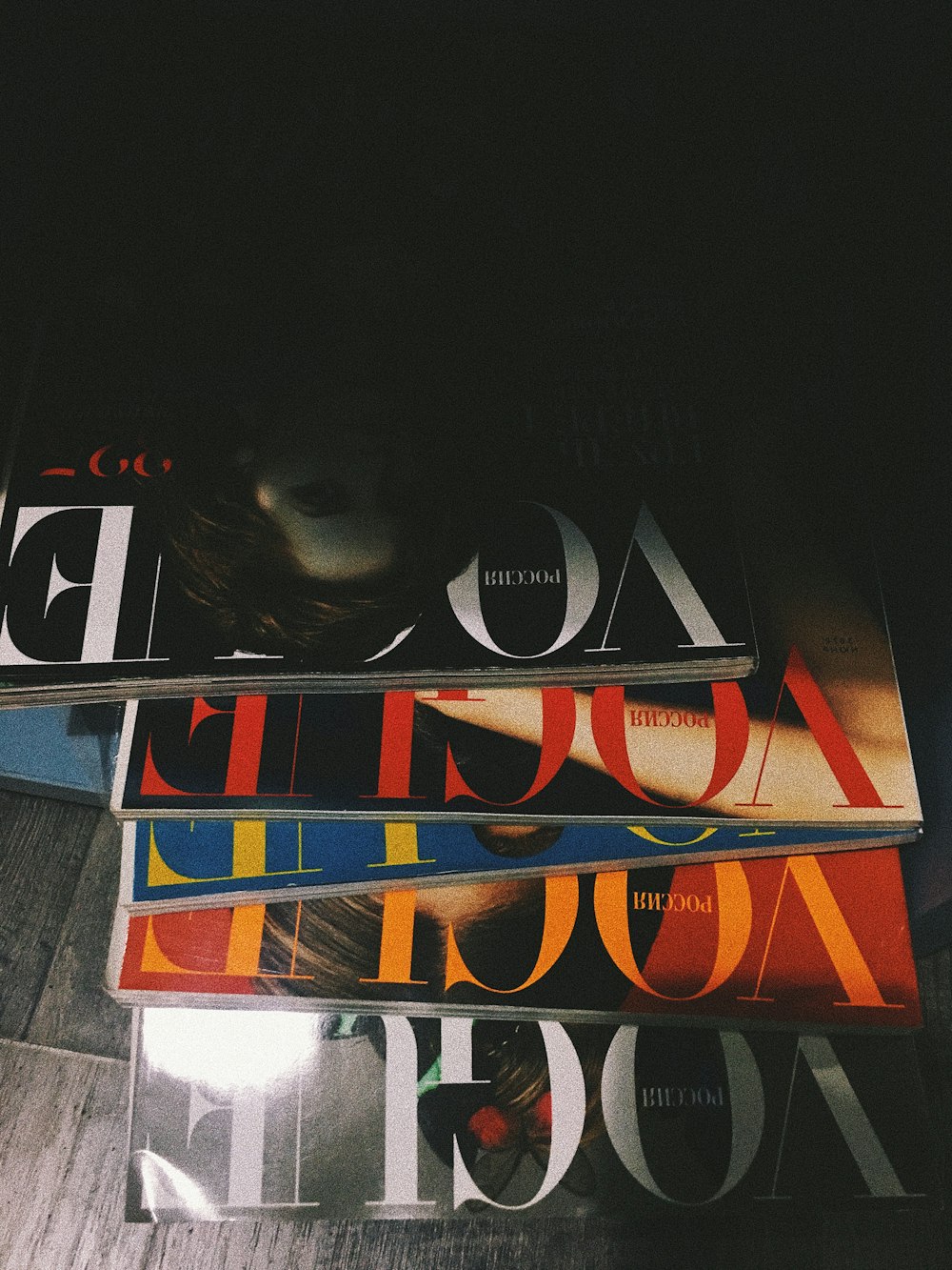 five assorted Vogue magazines