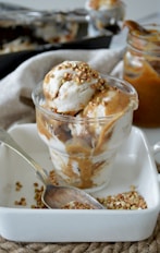 white and brown ice cream in cup close-up photography