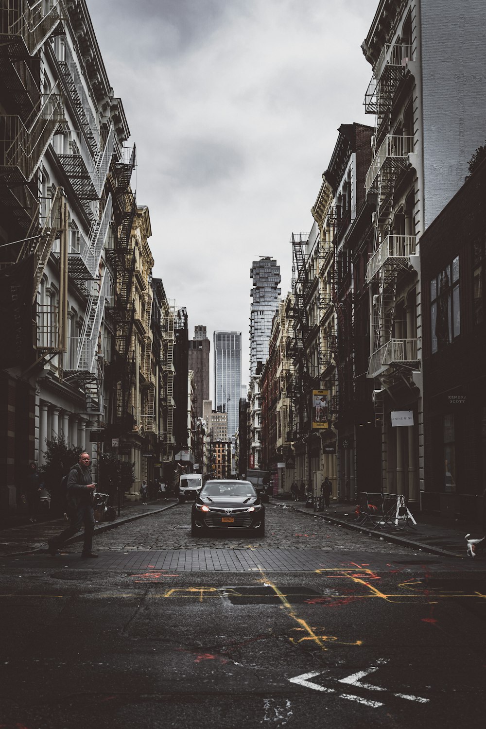 black vehicle between buildings at daytime