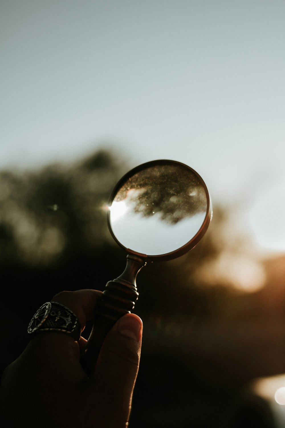 person holding magnifying glass