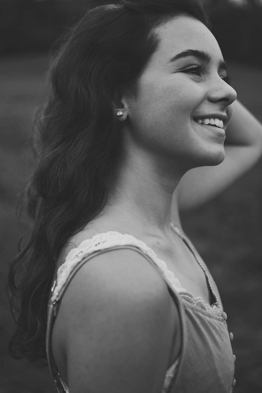 grayscale photo of woman wearing tank top looking at side