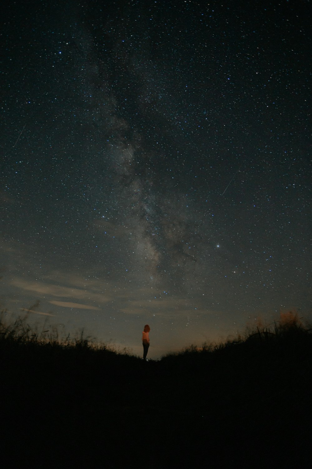 person standing on field during night time