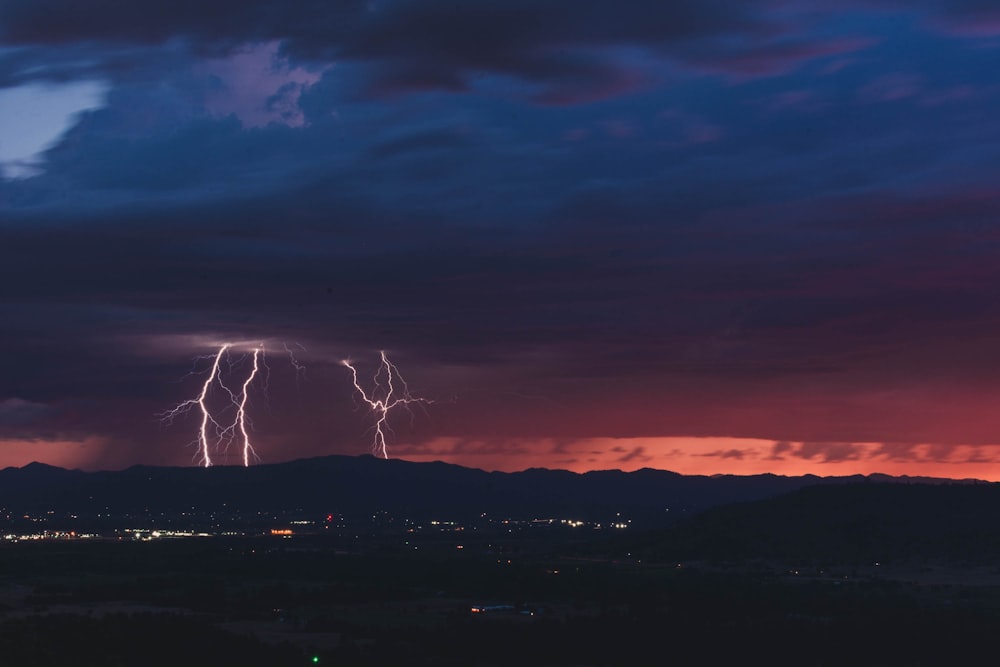 silhouette of mountain and lightning