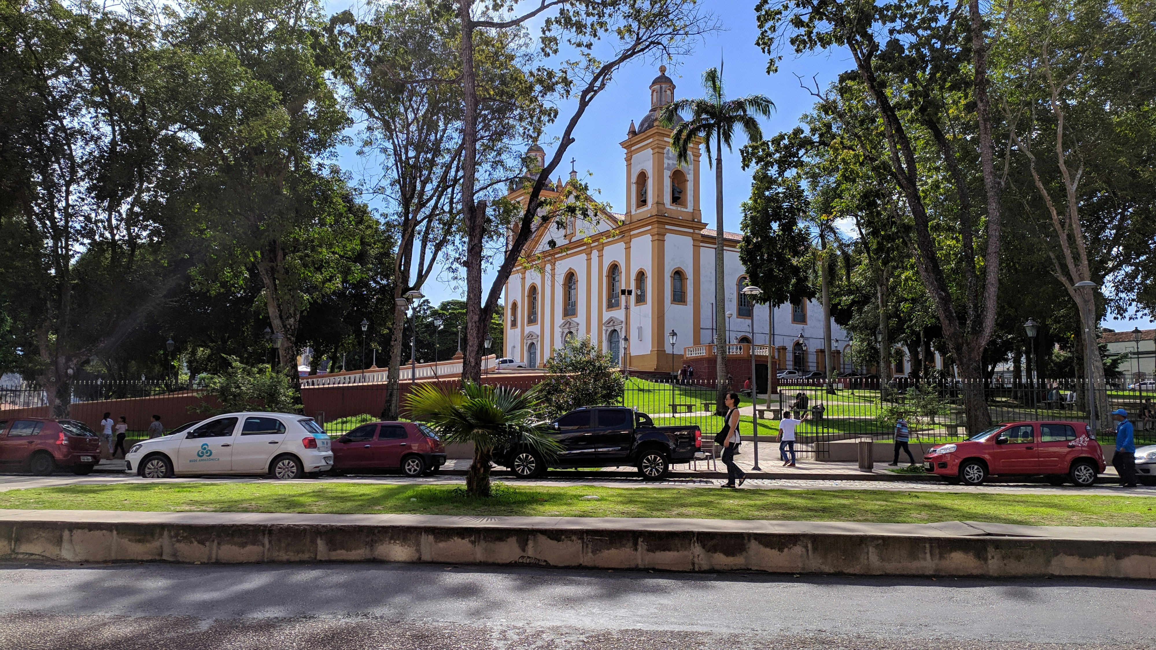 a church with a steeple surrounded by trees