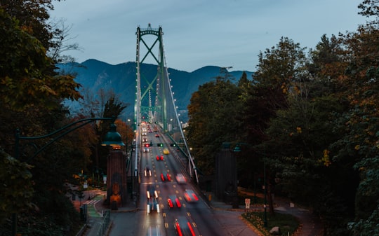photography of vehicles traveling on road during daytime in Lions Gate Bridge Canada