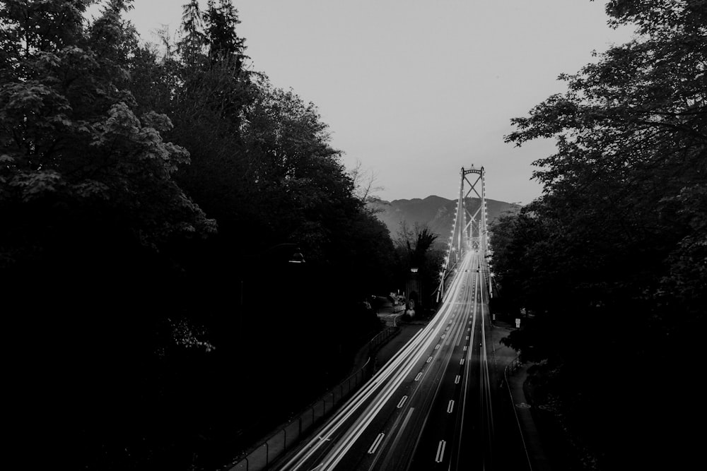 grayscale photography of vehicles traveling on road during daytime