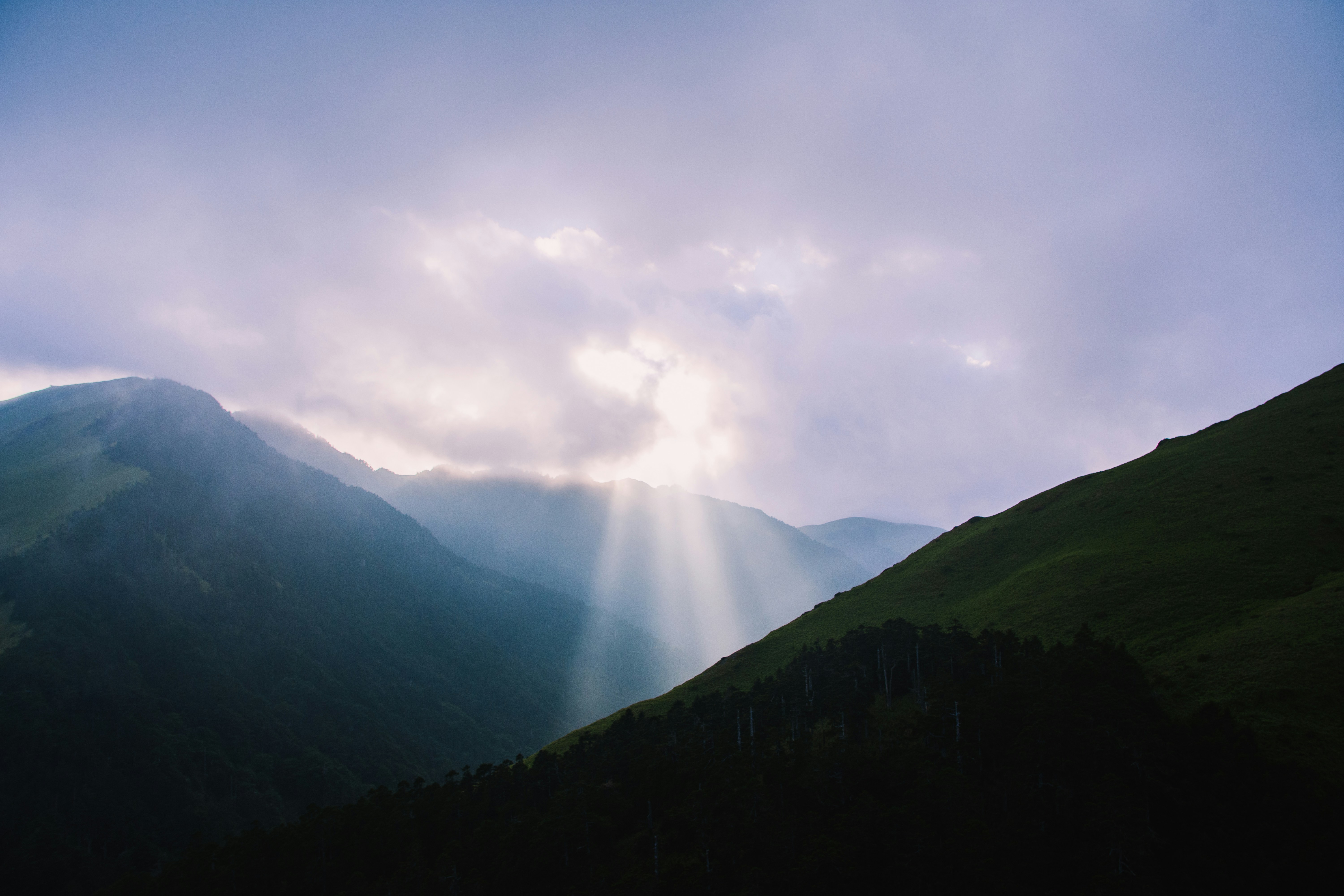 green mountains under white sky